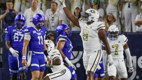 Tech players, including Georgia Tech Yellow Jackets defensive lineman Makius Scott (8) celebrate after holding the Panthers on a goal line stand during the first half of a NCAA football game between the  Georgia State Panthers and the Georgia Tech Yellow Jackets at Bobby Dodd Stadium in Atlanta on Saturday, Aug. 31, 2024.   (Bob Andres for the Atlanta Journal Constitution)