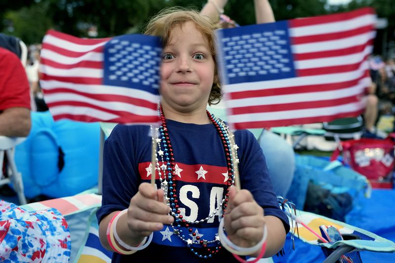 Brayden Chevalier, of Plastow, N.H., celebrates during the Boston Pops Fireworks Spectacular at the Hatch Memorial Shell on the Esplanade in Boston, Thursday, July 4, 2024. (AP Photo/Michael Dwyer)