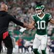 New York Jets wide receiver Allen Lazard (10) is congratulated by New York Jets head coach Robert Saleh after Lazard scored a touchdown against the New England Patriots during the first quarter of an NFL football game, Thursday, Sept. 19, 2024, in East Rutherford, N.J. (AP Photo/Adam Hunger)