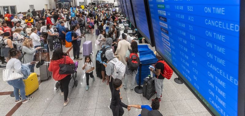 Travelers in the North Terminal of Hartsfield-Jackson Atlanta International Airport head to ticket counters on July 19 as a massive outage affected Microsoft users around the globe, disrupting airlines, railways, banks, stock exchanges and other businesses. (John Spink/The Atlanta Journal-Constitution)