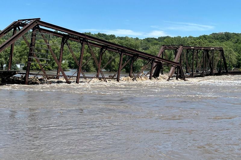 A railroad bridge connecting North Sioux City, S.D., with Sioux City, Iowa, is seen partially collapsed into the Big Sioux River due to flooding on Monday, June 24, 2024. (AP Photo/Margery A. Beck)