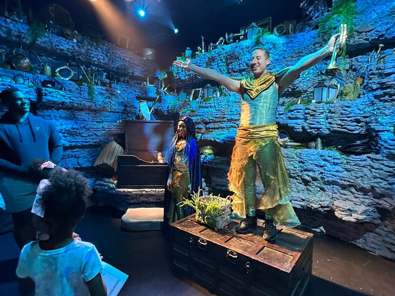 "The Little Mermaid" experience features a comedy show that was hosted by Albie (Rob Millerick) with Cassanda (Madina Robinson) on opening day June 3, 2023. RODNEY HO/rho@ajc.com