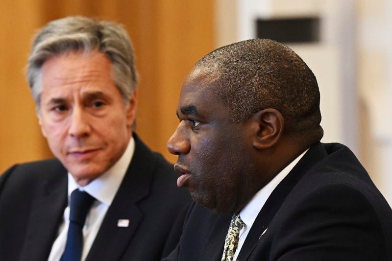 US Secretary of State Antony Blinken, left, listens as UK Foreign Secretary David Lammy, right, speaks during the Fourth Crimea Platform Leaders Summit in Kyiv, Ukraine, Wednesday, Sept. 11, 2024. (Leon Neal/Pool via AP)