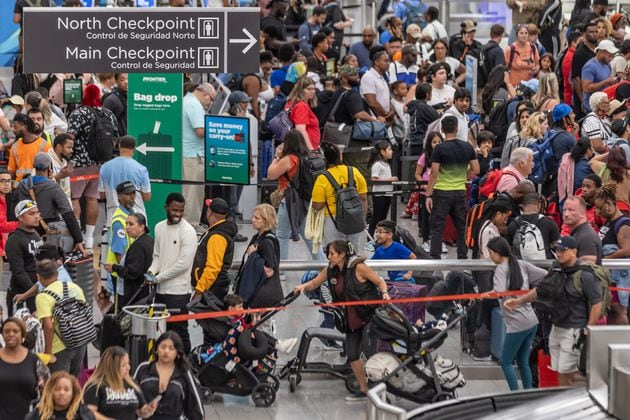 Travelers at Hartsfield-Jackson International Airport crowd around ticket counters on July 19, as a massive outage triggered by a security update from CrowdStrike affected Microsoft users around the globe, disrupting airlines, railways, banks, stock exchanges and other businesses. (John Spink/AJC 2024)