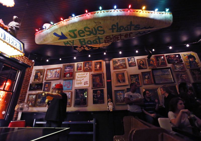 Owner Grant Henry participates in a pingpong tournament at Sister Louisa’s Church of the Living Room and Ping Pong Emporium. At times, the dive bar has been the hangout of celebrities including Lady Gaga, Ben Stiller and Owen Wilson. BOB ANDRES / BANDRES@AJC.COM 2014