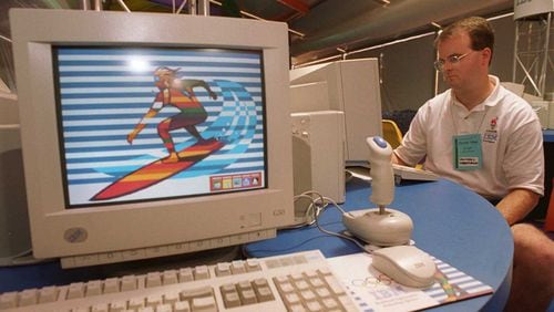 IBM employee Mike Underwood surfs on the internet in the "IBM Surf Shak" inside the Olympic Village in July 1996. The "Surf Shak" was designed to give athletes access to the internet and email, at a time when those technologies were still very new. (David Tulis / AJC file)