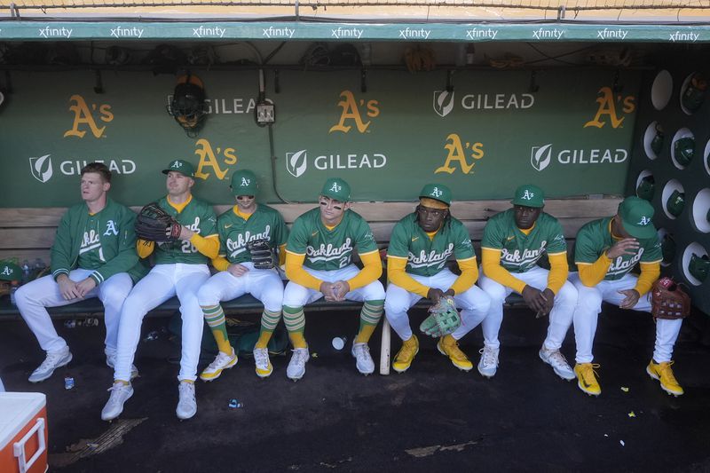 Oakland Athletics players wait to take the field before a baseball game against the Texas Rangers in Oakland, Calif., Wednesday, Sept. 25, 2024. (AP Photo/Jeff Chiu)