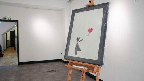 A Banksy painting, Girl With Balloon, on display at the Grove Gallery in London after it was stolen on Sunday, then recovered and returned to the gallery, Friday Sept. 13, 2024. (James Manning/PA via AP)