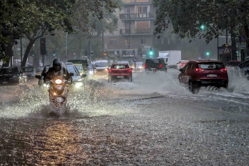 Residents wade through flooded streets in Milan, northern Italy, Thursday, Sept. 5, 2024. Lombardy and Veneto have been hit by widespread flooding, causing damage and disruption in the city of Milan, where the local Seveso and Lambro rivers overflowed. (Claudio Furlan/LaPresse via AP)