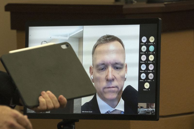 Trump 2020 Election Day operations director Michael Roman appears via video during his arraignment in Maricopa County Superior Court, Friday, June 7, 2024, in Phoenix. Roman pleaded not guilty Friday to nine felony charges for his role in an effort to overturn Trump's Arizona election loss to Joe Biden. (Mark Henle/The Arizona Republic via AP)