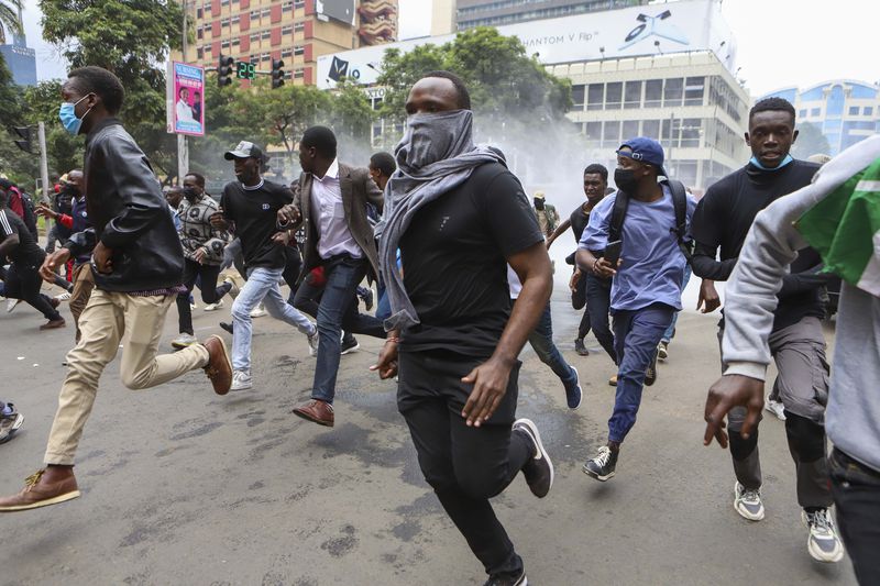 Demonstrators run from police during a protest over proposed tax hikes in a finance bill that is due to be tabled in parliament in Nairobi, Kenya, Thursday, June 20, 2024. AP Photo/ Andrew Kasuku)