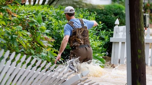 Walt Deriso walks on deep water outside his home in a flooded street by Battleview Dr. in the Hanover West neighborhood on Friday, Sept. 27, 2024, in the aftermath of heavy rain from Hurricane Helene.
(Miguel Martinez / AJC)