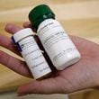 FILE - Bottles of abortion pills mifepristone, left, and misoprostol, right, are displayed at a clinic in Des Moines, Iowa, Sept. 22, 2010. (AP Photo/Charlie Neibergall, File)