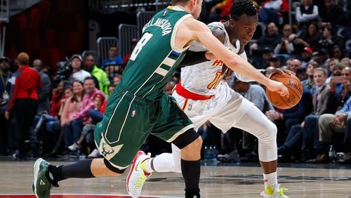 ATLANTA, GA - NOVEMBER 16: Dennis Schroder #17 of the Atlanta Hawks drives against Matthew Dellavedova #8 of the Milwaukee Bucks at Philips Arena on November 16, 2016 in Atlanta, Georgia. NOTE TO USER User expressly acknowledges and agrees that, by downloading and or using this photograph, user is consenting to the terms and conditions of the Getty Images License Agreement. (Photo by Kevin C. Cox/Getty Images)