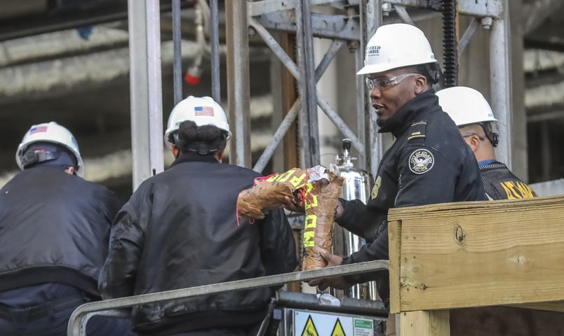 Two people locked themselves to construction equipment in Midtown to protest Atlanta’s planned public safety training center, causing a street to close amid the Monday morning commute, Jan. 29, 2024. The activists used reinforced bindings to lock their arms around the equipment at a Brasfield & Gorrie work site at 12th and Juniper streets. One person was locked to a construction elevator and the other to a boom. Both were released by 10:15 a.m. Juniper Street was closed to traffic for hours Monday morning before reopening around 11:30 a.m. SWAT team members were also at the scene for assistance in cutting the activists free. Brasfield & Gorrie is one of the contractors hired to build the training facility at the site of the old Atlanta Prison Farm in the south DeKalb County woods. Those opposed to the facility say its construction will damage the South River Forest and contribute to what they say is the militarization of the police department. (John Spink / John.Spink@ajc.com)

