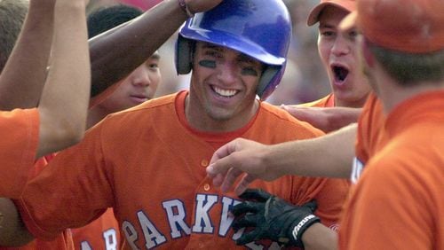 Parkview High School's Jeff Francoeur (center) is celebrated by teammates at a 7th inning homer run in the first game of the 2002 Georgia State AAAAA baseball championship series against Lassiter. Parkview won 5-4.