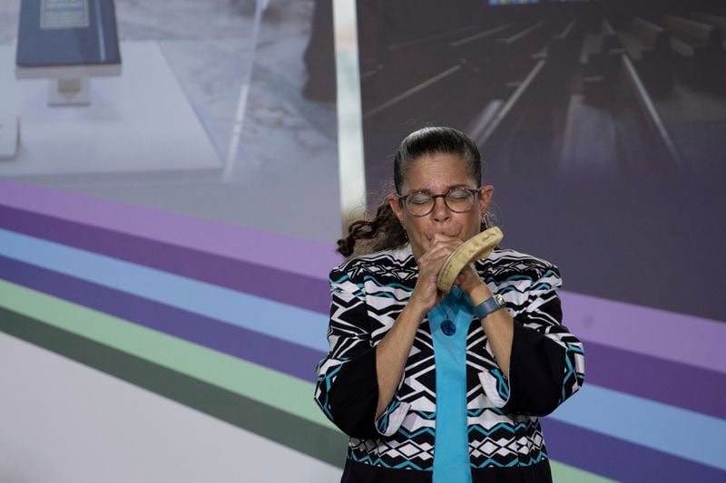 Audrey Glickman, a 10/27 survivor, sounds the shower during the groundbreaking ceremony for the new Tree of Life complex in Pittsburgh, Sunday, June 23, 2024. The new structure is replacing the Tree of Life synagogue where 11 worshipers were murdered in 2018 in the deadliest act of antisemitism in U.S. history. (AP Photo/Rebecca Droke)
