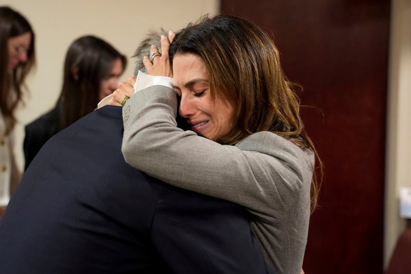 Actor Alec Baldwin, left, and his wife Hilaria embrace after a judge threw out the involuntary manslaughter case for the 2021 fatal shooting of cinematographer Halyna Hutchins during filming of the Western movie "Rust," Friday, July 12, 2024, in Santa Fe, N.M. (Ramsay de Give/Pool Photo via AP)