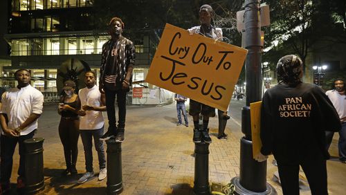Demonstrators take to the streets of uptown during a peaceful march following Tuesday's police shooting of Keith Lamont Scott in Charlotte, N.C., Thursday, Sept. 22, 2016. (AP Photo/Gerry Broome)