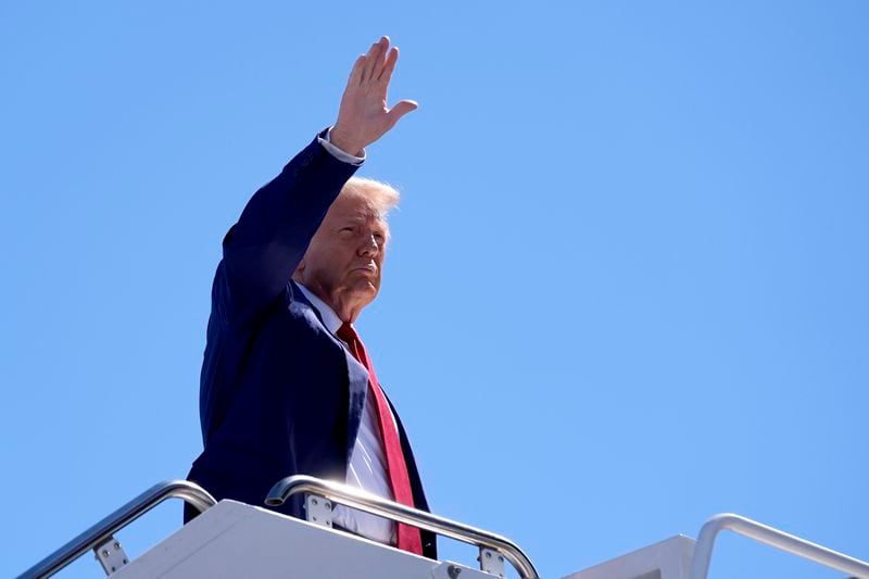 Republican presidential nominee former President Donald Trump waves as he boards a plane at Harry Reid International Airport after a campaign trip, Saturday, Sept.14, 2024, in Las Vegas. (AP Photo/Alex Brandon)