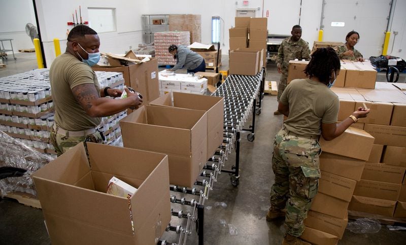 National Guard member Marquis Jordan loads boxes of supplies. STEVE SCHAEFER FOR THE ATLANTA JOURNAL-CONSTITUTION