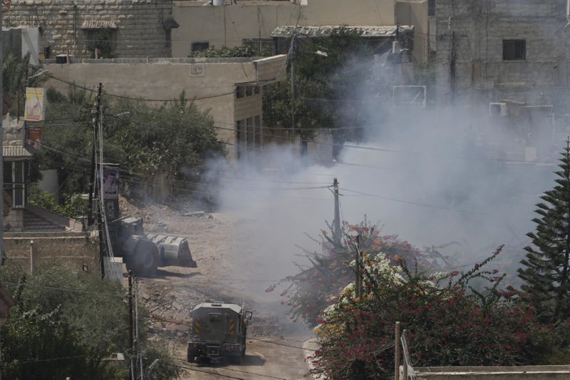 Smoke rises after an explosion during an Israeli military operation in the West Bank Jenin refugee camp, Saturday, Aug. 31, 2024. (AP Photo/Majdi Mohammed)