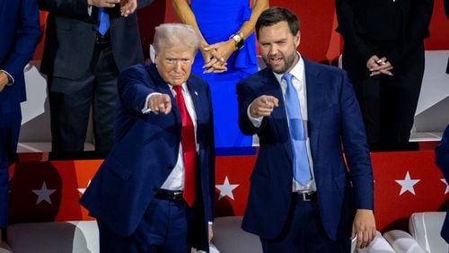 Former president Donald Trump (left) and running mate JD Vance (right) gesture to supporters at the Republican National Convention in Milwaukee on Monday.
