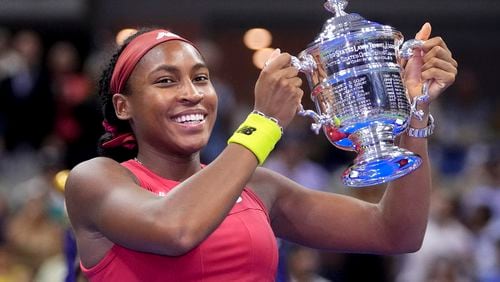 FILE - Coco Gauff holds up the championship trophy after defeating Aryna Sabalenka, of Belarus, in the women's singles final of the U.S. Open tennis championships, Saturday, Sept. 9, 2023, in New York. (AP Photo/Frank Franklin II, File)