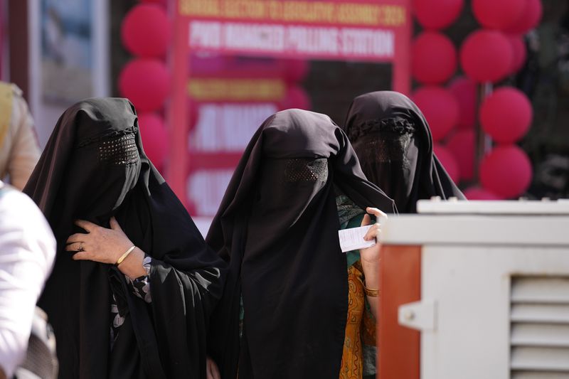 Muslim women voter queue up to cast their vote at a polling booth during the first phase of the Jammu and Kashmir assembly election, in Kishtwar, India, Wednesday, Sept. 18, 2024. (AP Photo/Channi Anand)