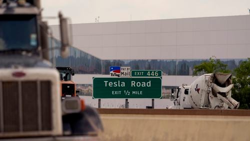 Vehicles pass the Tesla Gigafactory, Thursday, June 13, 2024, in Austin, Texas. Tesla shareholders are charting the future of the electric vehicle company as they wrap up voting whether or not to restore CEO Elon Musk's massive pay package that was thrown out by a Delaware judge. (AP Photo/Eric Gay)