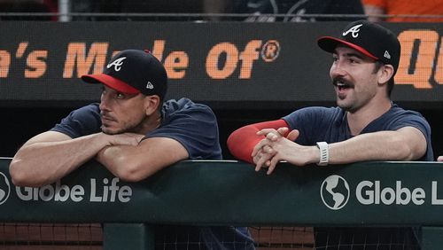 Injured Atlanta Braves pitcher Spencer Strider, right, and pitcher Charlie Morton watch from the dugout during a baseball game against the Detroit Tigers Tuesday, June 18, 2024, in Atlanta. (AP Photo/John Bazemore)