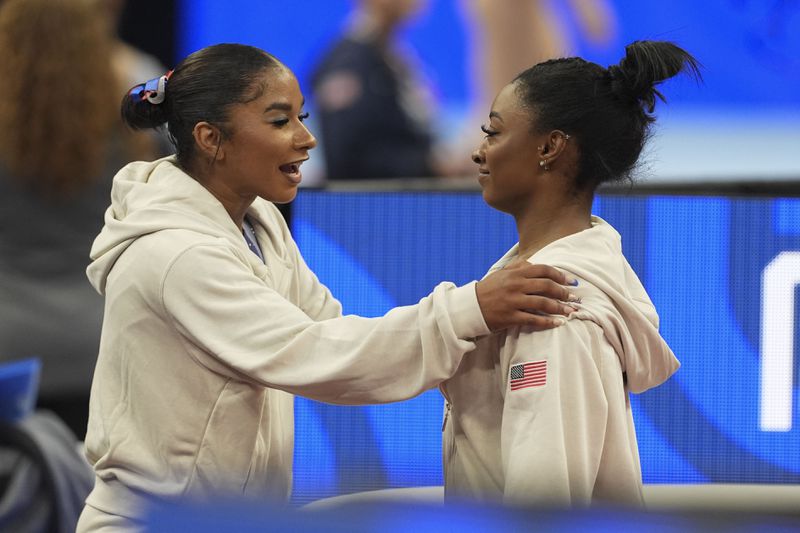 Simone Biles and Jordan Chiles speak between events at the United States Gymnastics Olympic Trials on Friday, June 28, 2024, in Minneapolis. (AP Photo/Abbie Parr)
