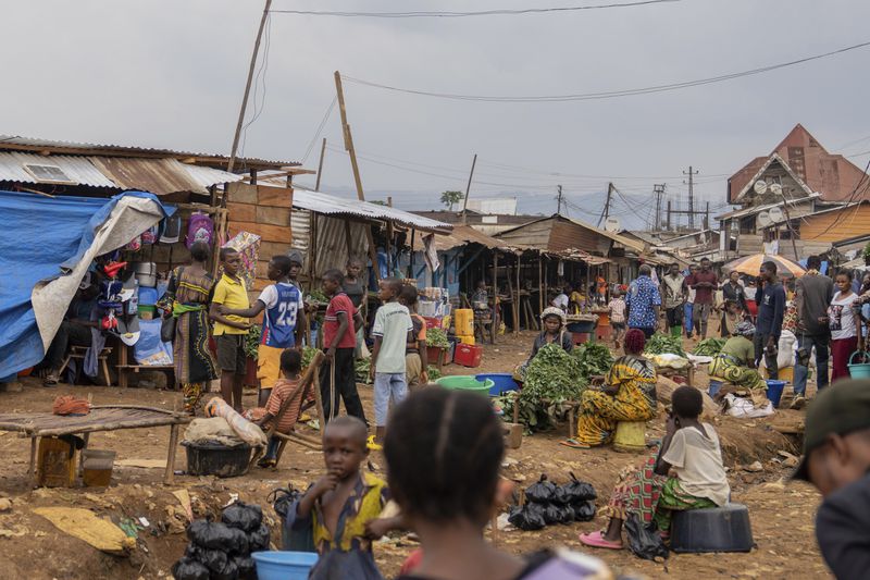 Women sell vegetables Wednesday, Sept. 4, 2024 in Kamituga, eastern Congo. (AP Photo/Moses Sawasawa)