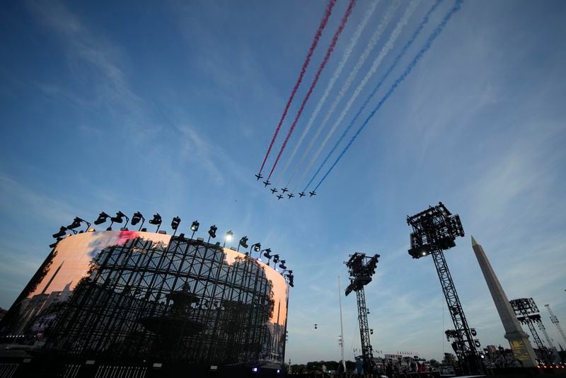 Alpha jets form the Patrouille de France fly over the Concorde plaza during the Opening Ceremony for the 2024 Paralympics, Wednesday, Aug. 28, 2024, in Paris, France. (AP Photo/Christophe Ena)