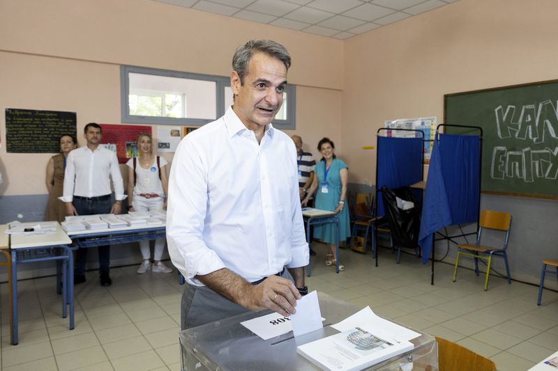 Greece's Prime Minister Kyriakos Mitsotakis casts his ballot during the European Elections in Athens, Sunday, June 9, 2024. Polling stations opened across Europe on Sunday as voters from 20 countries cast ballots in elections that are expected to shift the European Union's parliament to the right and could reshape the future direction of the world's biggest trading bloc. (AP Photo/Yorgos Karahalis)