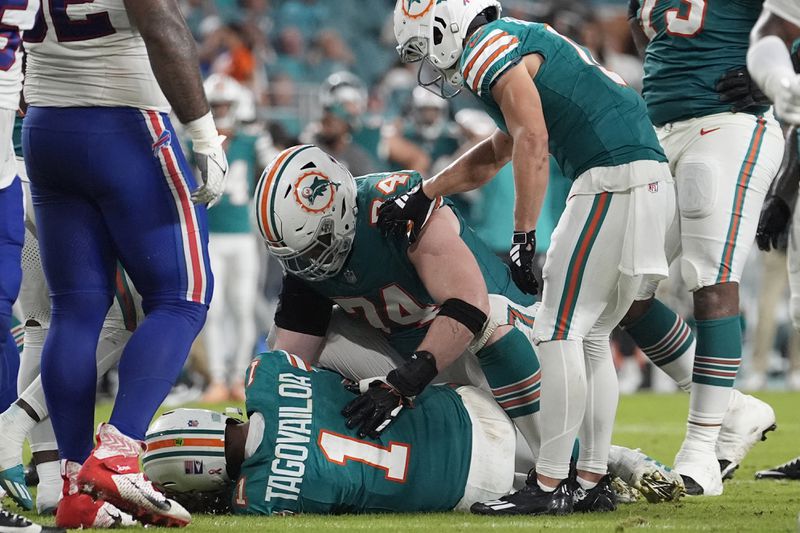 Miami Dolphins quarterback Tua Tagovailoa (1) lies on the field after suffering a concussion during the second half of an NFL football game against the Buffalo Bills, Thursday, Sept. 12, 2024, in Miami Gardens, Fla. (AP Photo/Lynne Sladky)