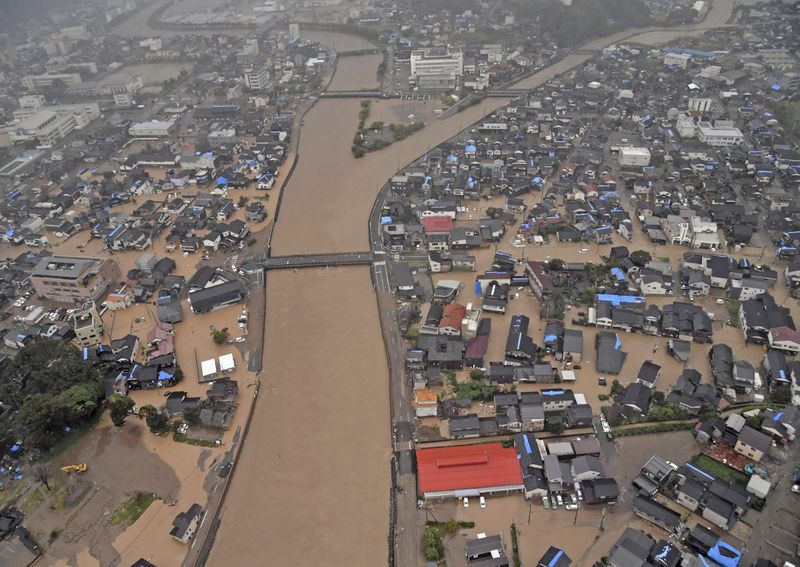 This aerial photo shows the flooded Kawarada river and submerged area after heavy rain in Wajima, Ishikawa prefecture, Saturday, Sept. 21, 2024. (Kyodo News via AP)