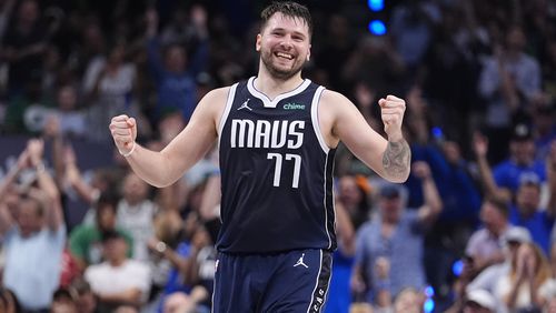 Dallas Mavericks guard Luka Doncic (77) reacts after a play during the first half in Game 4 of the NBA basketball finals against the Boston Celtics, Friday, June 14, 2024, in Dallas. (AP Photo/Julio Cortez)