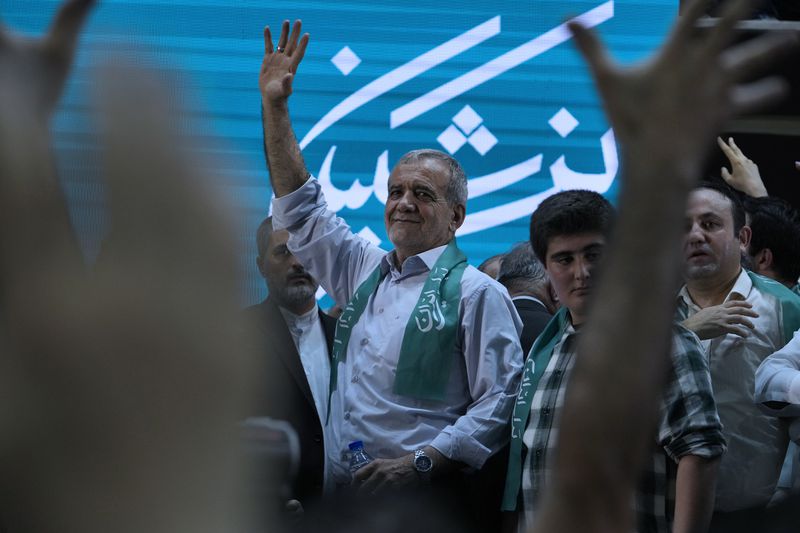 Reformist candidate for Iran's June 28, presidential election Masoud Pezeshkian waves to his supporters during his campaign rally in Tehran, Iran, Sunday, June 23, 2024. (AP Photo/Vahid Salemi)
