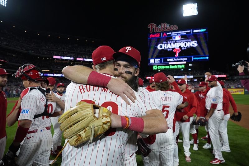 Philadelphia Phillies' Brandon Marsh, right, and Jeff Hoffman celebrate after winning a baseball game against the Chicago Cubs to clinch the NL East title, Monday, Sept. 23, 2024, in Philadelphia. (AP Photo/Matt Slocum)