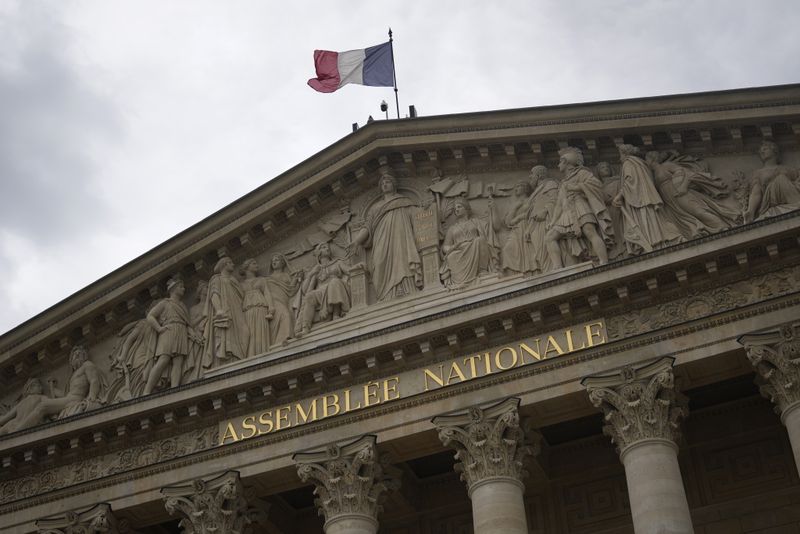 The French flag flies atop the French National Assembly Wednesday, July 3, 2024 in Paris. French President Emmanuel Macron dissolved the National Assembly and called the snap election on June 9 after a stinging defeat at the hands of the National Rally in French voting for the European Parliament. The second round of the legislative will take place Sunday July 7. (AP Photo/Thibault Camus)