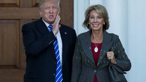 BEDMINSTER TOWNSHIP, NJ - NOVEMBER 19: (L to R) president-elect Donald Trump and Betsy DeVos pose for a photo after their meeting at Trump International Golf Club, November 19, 2016, in Bedminster Township, New Jersey. (Photo by Drew Angerer/Getty Images)