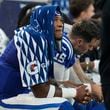 Indianapolis Colts quarterback Anthony Richardson, left, sits on the bench after being injured during the first half of an NFL football game against the Pittsburgh Steelers, Sunday, Sept. 29, 2024, in Indianapolis. (AP Photo/Darron Cummings)