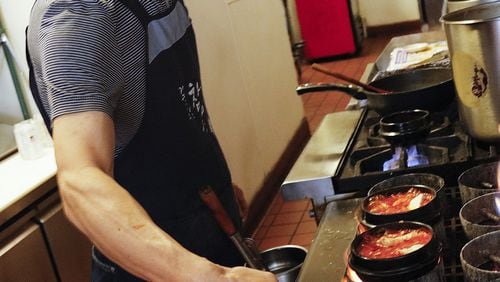 Pong-yun Kim, chef-owner of Kimchi Tofu House in Minneapolis, cooks sundubu through the lunch hour. (Tom Wallace/Minneapolis Star Tribune/TNS)