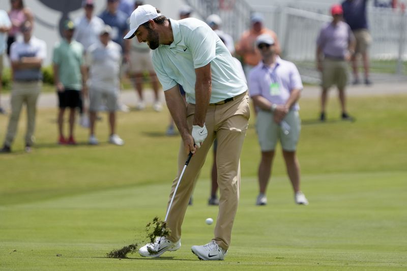 Scottie Scheffler hits from the 18th fairway during the second round of the St. Jude Championship golf tournament Friday, Aug. 16, 2024, in Memphis, Tenn. (AP Photo/Mark Humphrey)