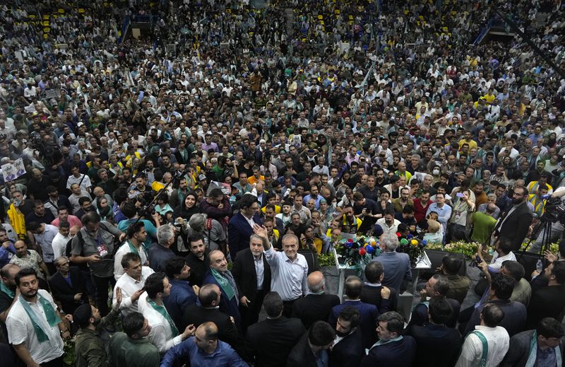 Reformist candidate for Iran's June 28, presidential election Masoud Pezeshkian, bottom center, waves to members of the media during his campaign rally in Tehran, Iran, Sunday, June 23, 2024. (AP Photo/Vahid Salemi)