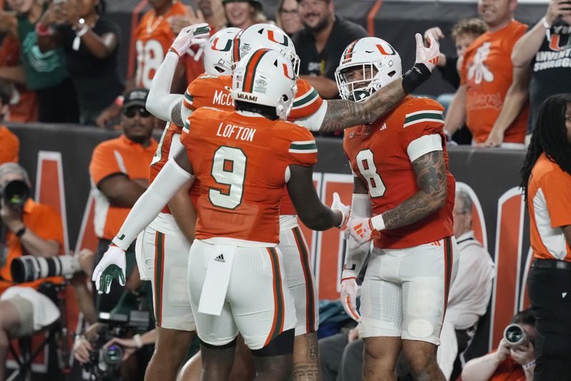 Miami tight end Elijah Arroyo (8) celebrates a touchdown during the first half of an NCAA college football game against Virginia Tech , Friday, Sept. 27, 2024, in Miami Gardens, Fla. (AP Photo/Marta Lavandier)