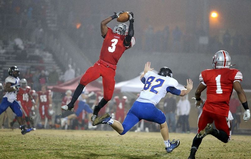 December 5, 2014 - Lawrenceville, Ga: Archer defensive back Dylan Singleton (3) makes an interception over Etowah tight end Patrick Oliver (82) in the first half of their game against Etowah in the Class AAAAAA semifinal Friday night at Archer High School in Lawrenceville, Ga., December 5, 2014. Singleton returned the interception for a touchdown. PHOTO / JASON GETZ