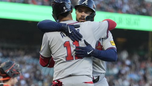 Atlanta Braves' Travis d'Arnaud, right, is congratulated by Orlando Arcia after hitting a home run against the San Francisco Giants during the third inning of a baseball game in San Francisco, Tuesday, Aug. 13, 2024. The Braves won 4-3  in 10 innings. (AP Photo/Jeff Chiu)