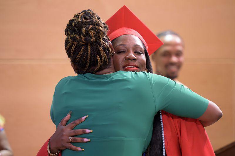 Sparkle Graham, right, is recognized for her achievement during a high school equivalency (HiSET) diploma graduation ceremony for the Youth Empowerment Project (YEP) in New Orleans, Thursday, June 27, 2024. (AP Photo/Matthew Hinton)